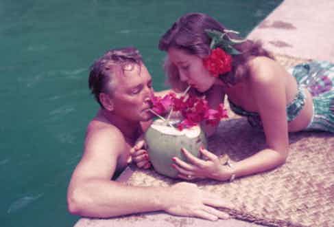 Teddy Stauffer and a friend share a drink from a coconut shell, Acapulco, Mexico, 1952 (Photoraph by Slim Aarons)