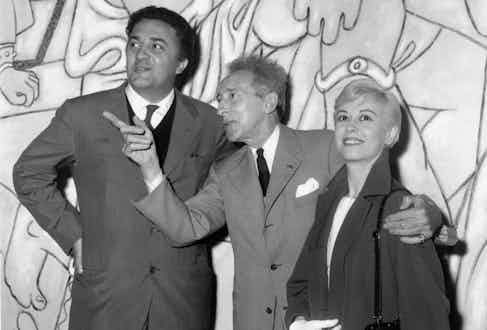 Federico Fellini and Giulietta Masina visiting the Saint Peter chapel decorated by Jean Cocteau, 1957 in Villefranche sur mer, France during Cannes film festival.
