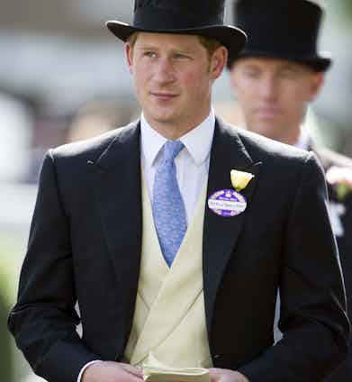 Prince Harry wearing a buff coloured double-breasted waistcoat underneath his perfectly fitting morning coat at Ascot in 2014. He boldly chose to forgo the pocket square, which gives his top half a clean, minimal appeal.