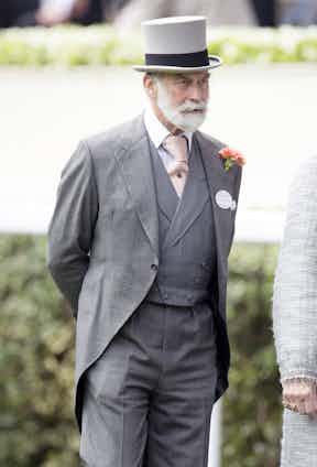 Prince Michael of Kent showcasing his trademark Windsor tie knot complete with complementary lapel flower.