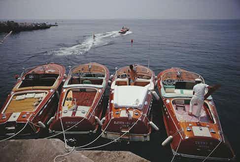 A lineup of Riva speedboats docked outside the Hôtel du Cap, 1969. Photo by Slim Aarons.