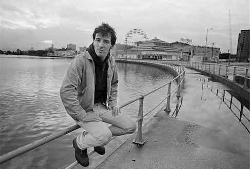 Forever casual in a lightweight jacket, straight leg trousers and a hooded jumper on the boardwalk in Asbury Park, New Jersey, 1979. Photograph by Joel Bernstein.