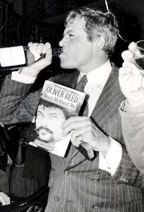 Reed at the launch of his book, ‘Reed All About Me’, with his staple drink in hand, 1979. Photograph by Bill Cross/Daily Mail/REX/Shutterstock.