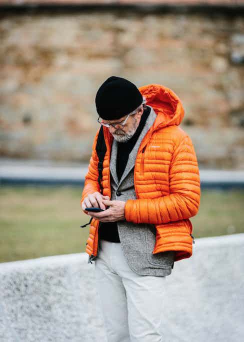 Layered over tailoring in a bold colour such as crimson or orange warms up an otherwise monochrome outfit. Photo by Jamie Ferguson.