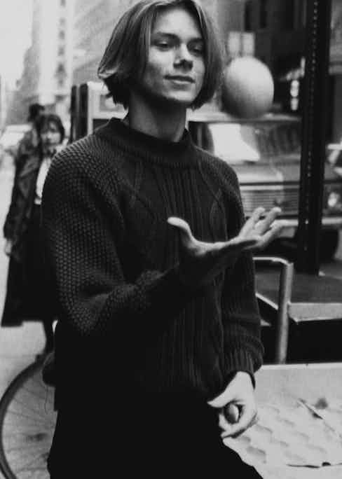 Phoenix wears a cable knit sweater in New York, circa 1990s. Photograph by John Roca