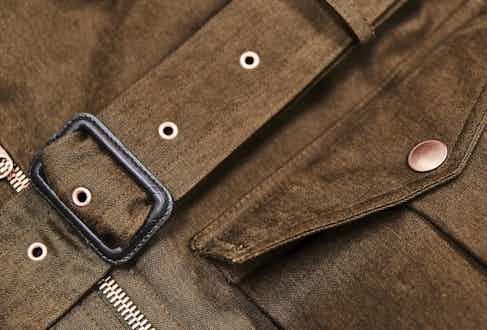 D-Ring belt buckle and copper rivets reinforce the jacket.