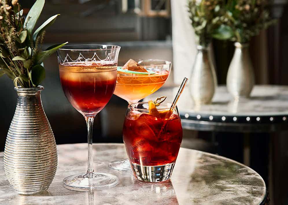The Connaught Bar's three variations of the Negroni: 'Negroni 10 to 100'; 'Sweet and Z' and the classic Negroni.