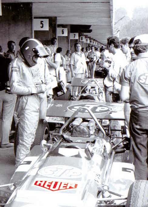 Siffert getting ready for a race, with Heuer logos on his suit and car