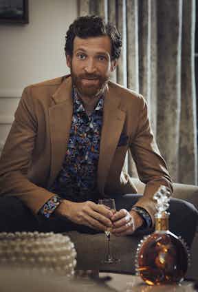 Camel wool jacket, De Petrillo; Retrofuture print shirt, Eton; Navy and brown cotton pocket square, Anderson & Sheppard; Grey wool trouser, Kit Blake. Louis XIII classic decanter and twin crystal glasses, both Louis XIII.