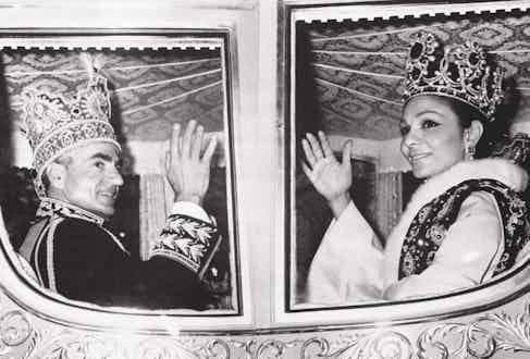 Waving with Farah from their carriage following their coronation ceremony in 1967 (Photo via Getty)