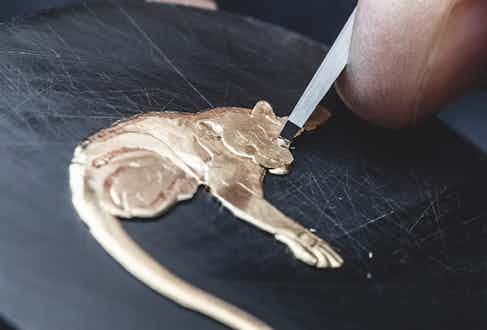 Hand-engraving the gold appliqué of the Formosa clouded leopard