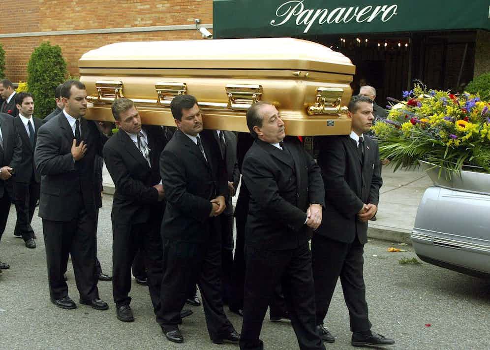 Being carried from his funeral, 2002 (PHOTO/Doug KANTER (Photo credit should read DOUG KANTER/AFP/Getty Images)