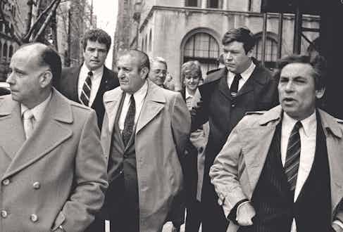 Paul Castellano, former mob boss, who Gotti had killed, is escorted by FBI agents following his surrender in 1984 (Photo by Thomas Monaster/NY Daily News Archive via Getty Images)