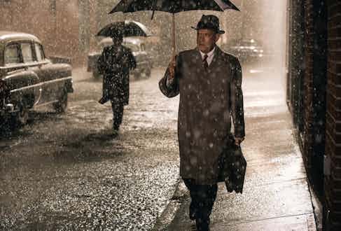 Tom Hanks wearing a mackintosh-style coat in Bridge of Spies, 2015.