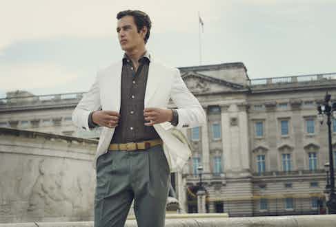 Off-white gabardine single-breasted jacket, brown linen shirt, dark sage trousers.