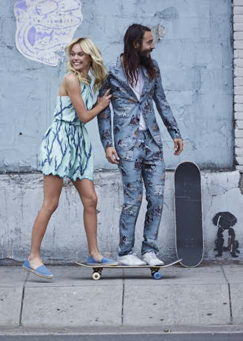 RAF-blue printed silk suit, Valentino, ivory cashmere-silk lightweight knitted T-shirt, Canali. White canvas trainer, Vans, property of the skater. On her: Cyan dress, Louis Vuitton, leopard-print blue pumps, Jimmy Choo.